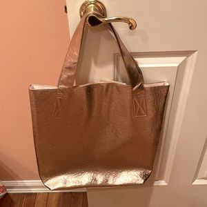 Gold tote bag fully lined with magnetic snap closure.